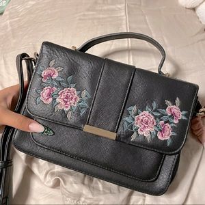 Black crossbody purse with stitched Flowers detail